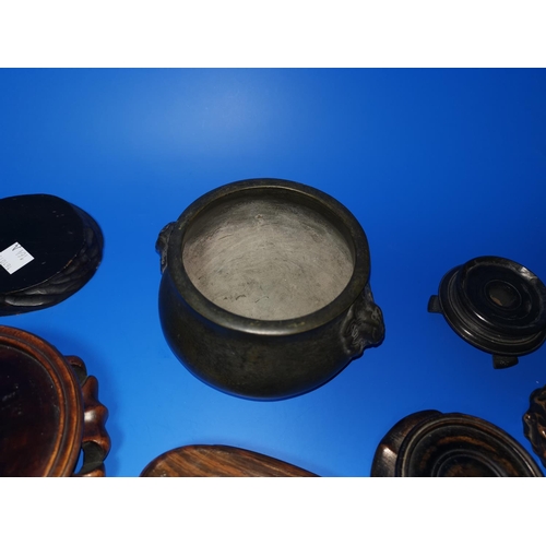164a - A Chinese bronze censer and a selection of hardwood stands