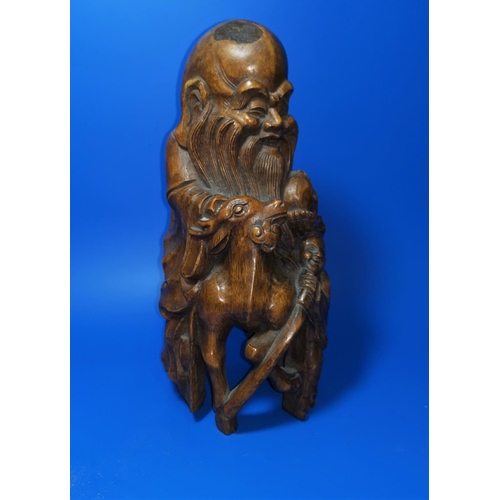 167B - A Chinese carved wood figure of a sgae, 31cm