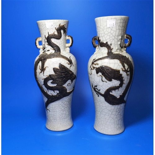 168A - A pair of Chinese crackle glaze vases decorated with dragons in brown, marks to bases, ht 30cm (chip... 