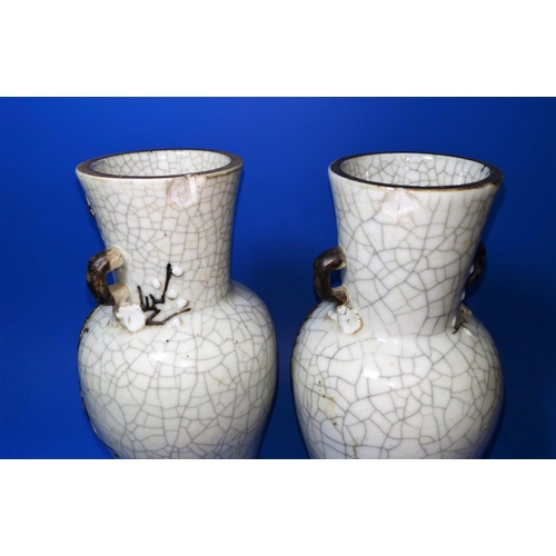 168A - A pair of Chinese crackle glaze vases decorated with dragons in brown, marks to bases, ht 30cm (chip... 
