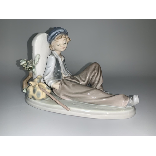 6 - A Lladro figure - young boy with knap sack leaning against a signpost 'N340'