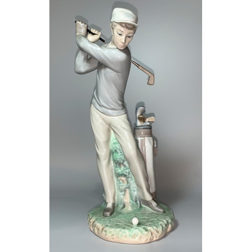 10 - A Lladro figure of a young man swinging a golf club with bag of clubs beside hi, height 28cm