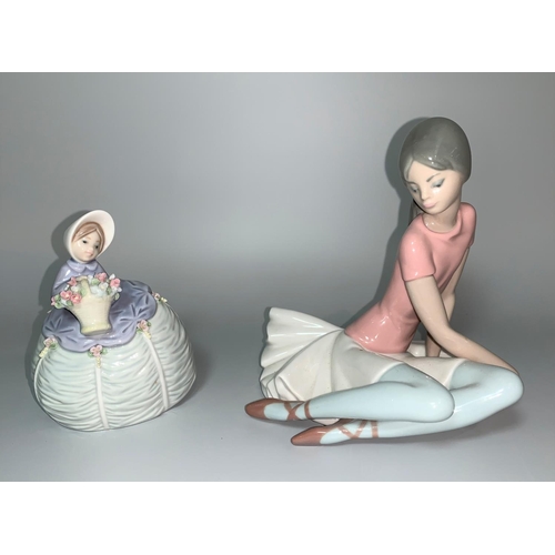 14 - Two Lladro figures - ballerina seated on floor, in pink top and a small Lladro crinoline lady with a... 