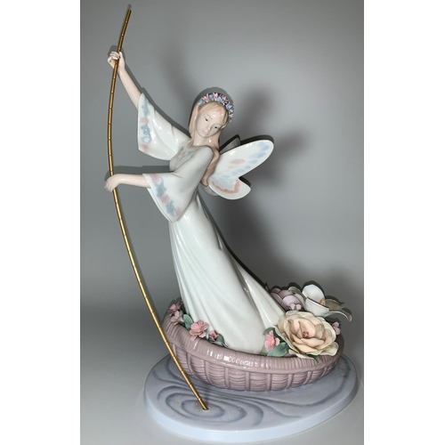24 - A large Lladro figure of a fairy in small boat with flowers, ht 37cm