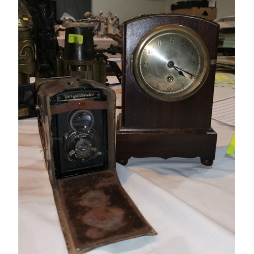 206 - An early 20th century German mantel clock and a Voigtlander camera