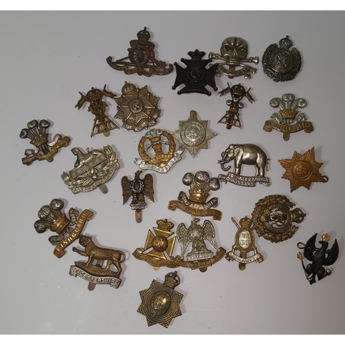540 - A collection of 24 British military cap badges
