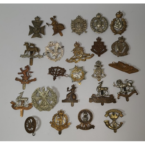 542 - A collection of 24 British military cap badges