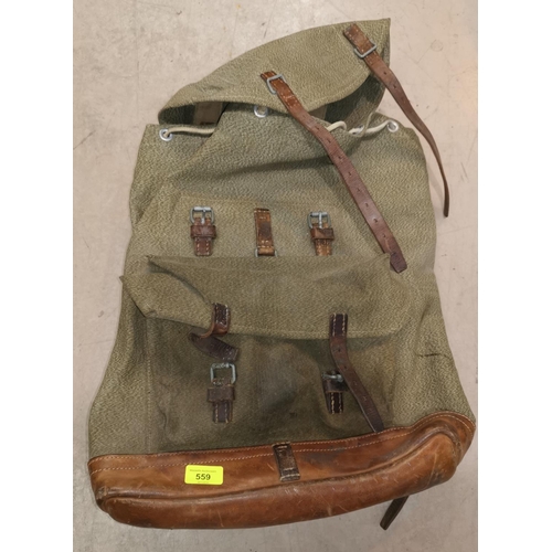 559 - A German pattern canvas back pack with leather straps and fittings