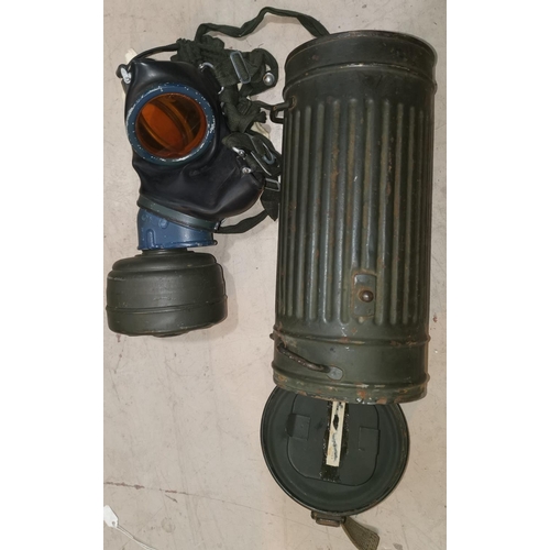 565 - A WWII German metal gas canister with original gas mask