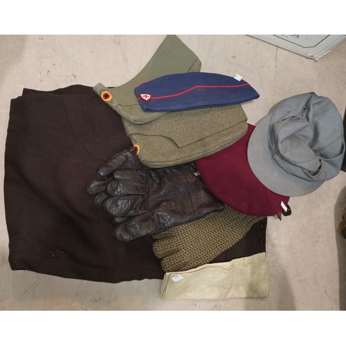 566 - A British paratrooper WWII copy beret, other headgear, gloves, a pair of German type trousers