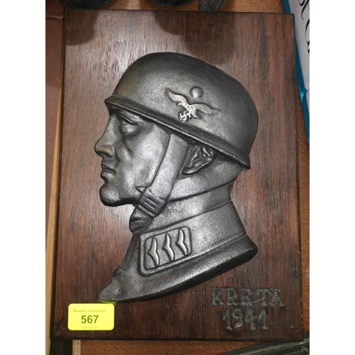 567 - A German cast iron plaque mounted on wood inscribed KRETA 1941 30cm overall