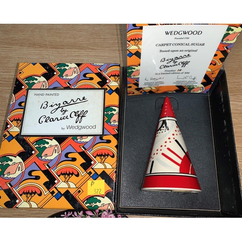 102 - A Wedgwood reproduction Clarice Cliff conical sugar with box and certificate, a decanter and a trio ... 