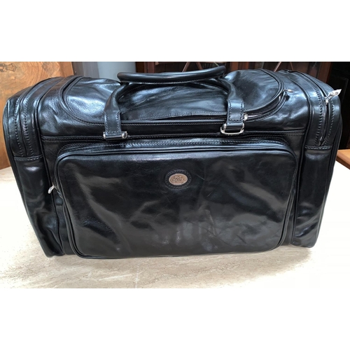 706 - An unused The Bridge Travel bag/hold all in black leather length 55cm, tags still attached.