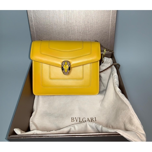 708 - A BULGARI Serpenti Forever saffron yellow and beige calf leather crossbody bag with snakehead magnet... 