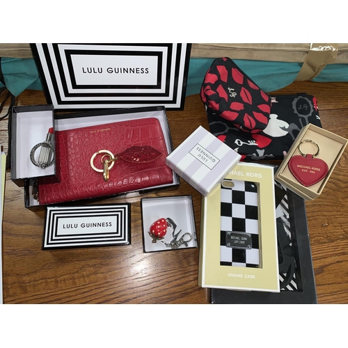 729 - A boxed LULU GUINNESS red purse; a similar lipstick key fob, boxed, a similar iphone 6/7 case; key f... 