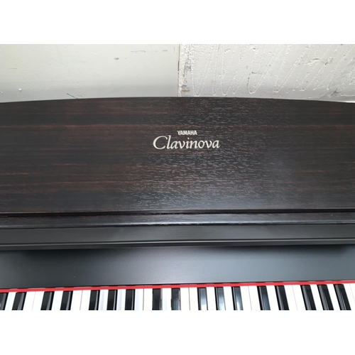 674 - A Yamaha Clavinova CLP - 153SG electronic piano with instructions in dark wood effect case