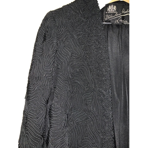 710a - A lady's 1950's vintage full length black crepe evening / cocktail coat with raised tube line effect... 