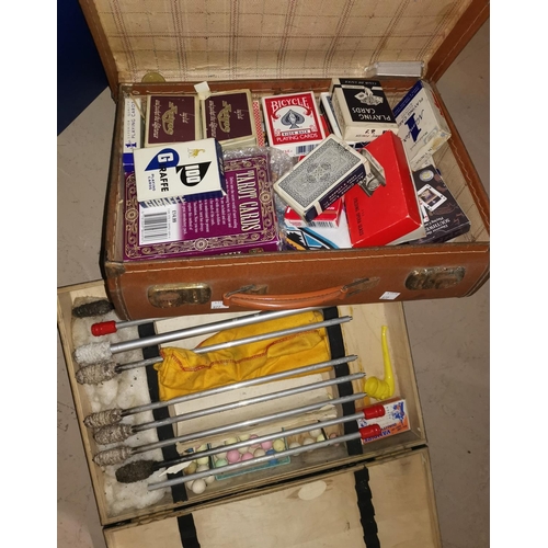 877 - A suitcase containing packs of cards; items of fire eating equipment