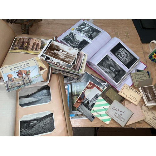 450 - A selection of postcards in albums & loose
