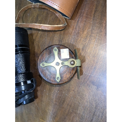805 - An early 20th century brass and wooden fishing reel and a pair of Ross 10 x 50 binoculars