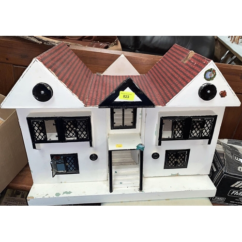 823 - A vintage twin gabled doll's house & furniture