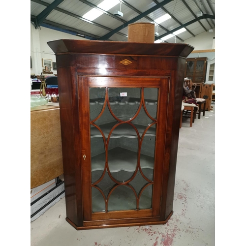 645 - A Georgian mahogany corner cabinet with astragal glazed door