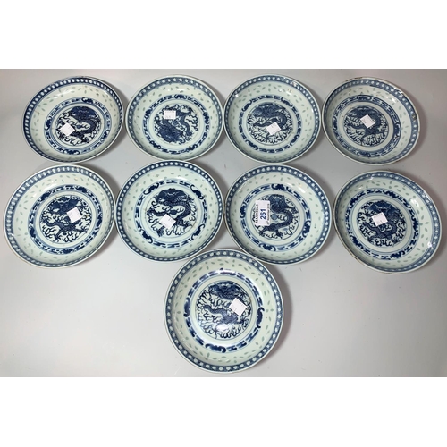 261 - A Chinese set of 9 porcelain saucers decorated in underglaze blue with dragons, 14.5 cm