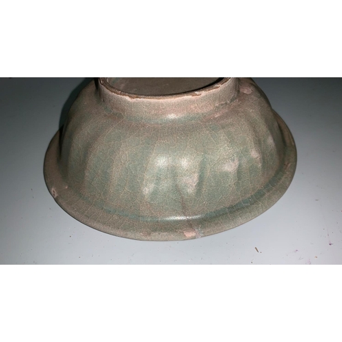294 - A Chinese small celadon glazed bowl with central impressed motif, diameter 13 cm