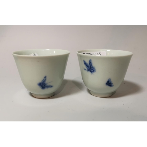 144 - A pair of blue and white tea bowls decorated with butterflies, 6 character signature to base, height... 