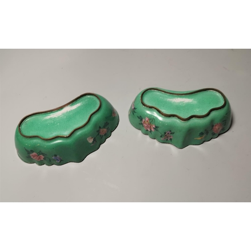 145 - A pair of Chinese kidney shaped canton enamel brush pots decorated with pink and blue flowers agains... 