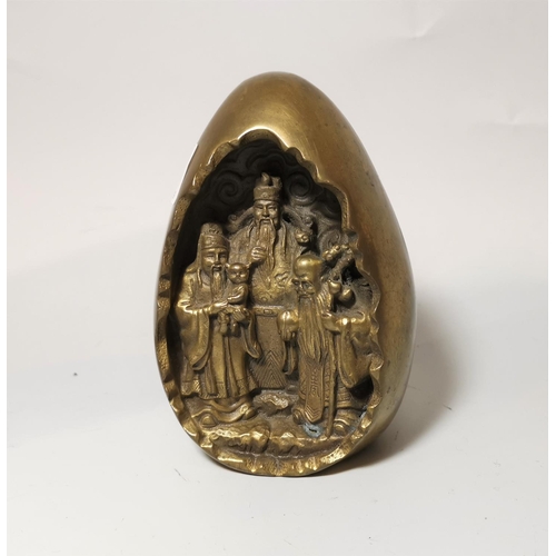 324 - A 20th century Chinese brass egg shaped object with sages to the interior