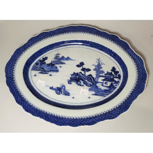 335a - A late 19th century Chinese oval platter, decorated in blue & white with pagodas and mountains in a ... 