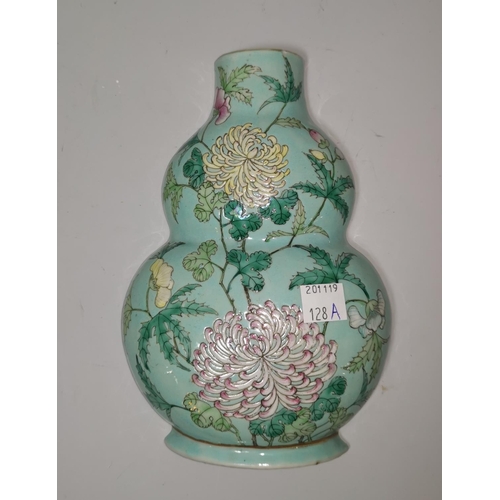 128a - A Chinese porcelain double gourd shaped wall vase decorated with chrysanthemums on pale blue ground,... 