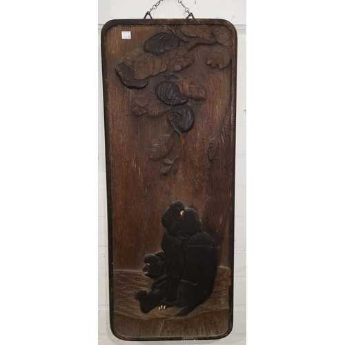 133a - A 19th century Japanese carved wood rectangular panel depicting monkeys looking up at persimmon frui... 