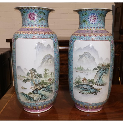 138a - A 20th century Chinese pair of large cylindrical vases decorated in the Cantonese manner with reserv... 