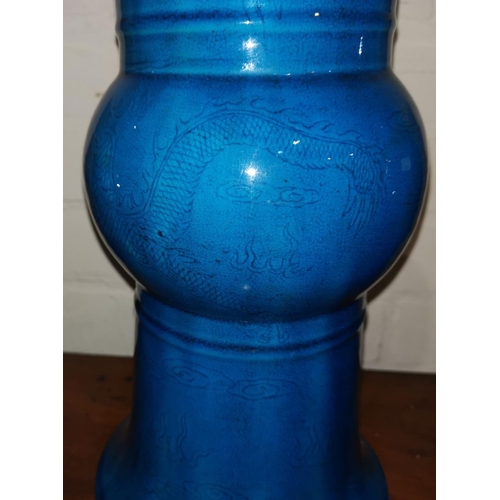 141 - A Chinese Kangxi beaker vase decorated in low relief with dragons and fish under bright turquoise gl... 