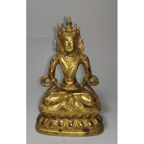 150 - A late 18th / early 19th century Chinese gilt bronze figure of Buddha in the lotus position, impress... 