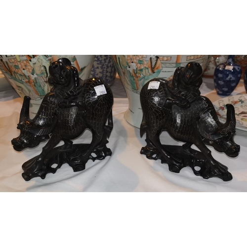 290b - A pair of Chinese hardwood group:  boys riding water buffalo, with silver wire inlay, length 19cm