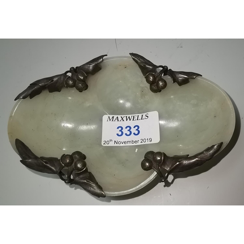 333 - A Chinese jade coloured hardstone dish of lobed oval form, decorated with stylized motifs in relief,... 