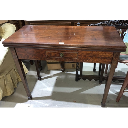 615 - An early 19th century mahogany tea table with rectangular fold-over top, on square tapering legs
