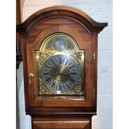 660a - A mahogany reproduction longcase clock with brass dial