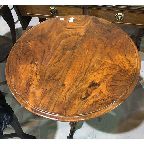 661 - A Victorian tripod table with circular figured walnut top, 57