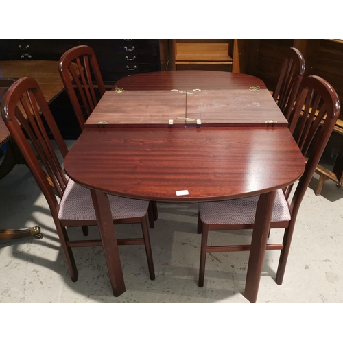 573 - A modern mahogany dining suite comprising extending table and 4 chairs