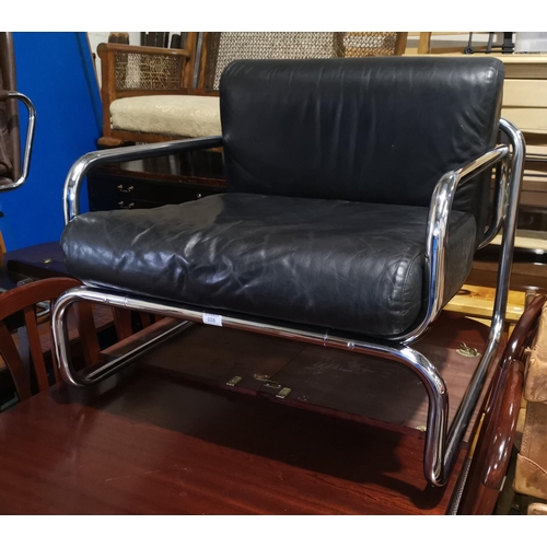 626 - A mid century deep armchair, chromed steel frame with black leather covered seat and back cushions