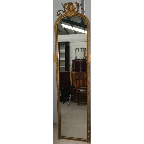 653 - A Victorian full length pier mirror in arch top gilt frame with ornate crest, height 198 cm