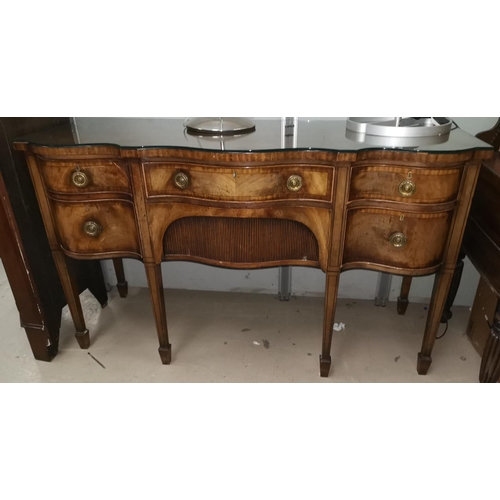 655A - A late 19th/early 20th century serpentine front mahogany sideboard with two cupboards and central dr... 