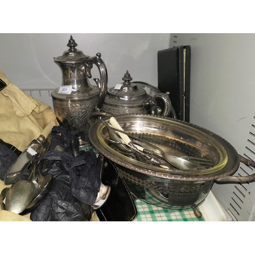 351 - A Victorian silver plated wine jug and teapot with chased decoration; other silver plate and cutlery