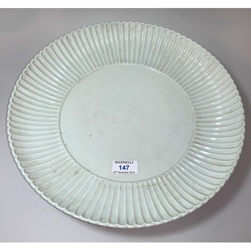 147 - A large Chinese 'Qing' white glazed shallow dish with raised fluted border, underglaze blue seal mar...