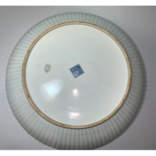 147 - A large Chinese 'Qing' white glazed shallow dish with raised fluted border, underglaze blue seal mar... 