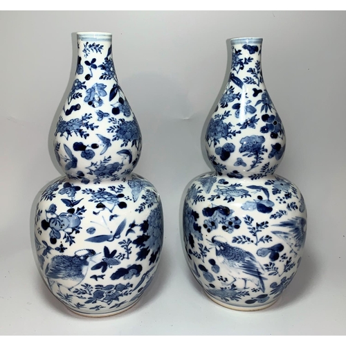 241 - A pair of Chinese Qing double gourd blue and white vases decorated with birds, flowers etc, 4 charac... 